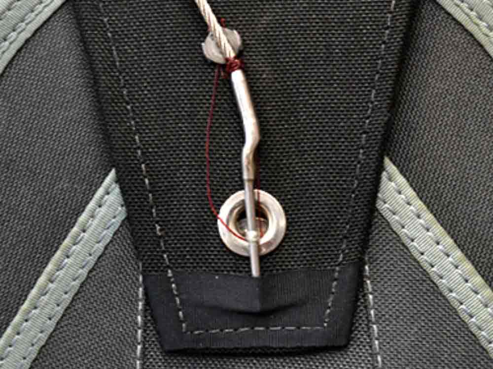 Reserve pin and closing loop detail Close-up detail of the reserve pin and closing loop on a parachute container, part of the reserve system.